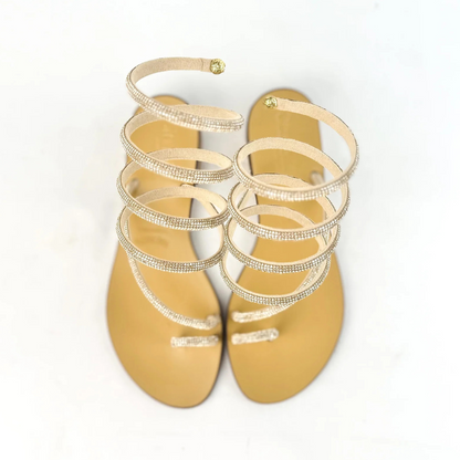 Sandálias rasas com tiras em espiral e brilhantes